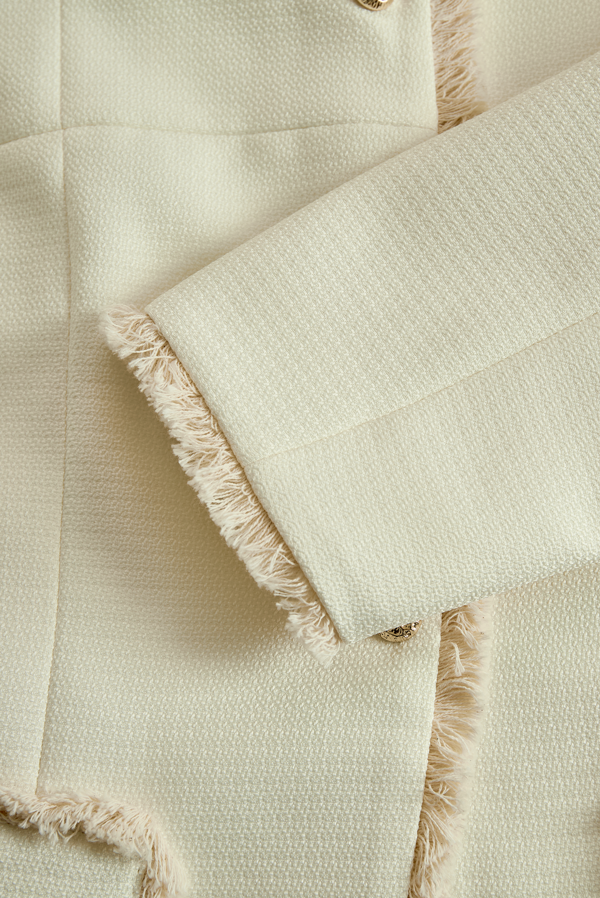 Blazer Zafren color crema con finiture sfrangiate e texture